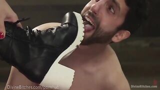 The strong woman in leather dominates her slave through wrestling