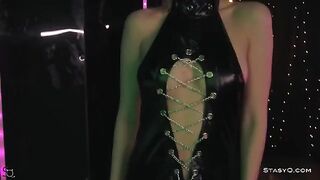 A hot teen in black underwear is stripping on stage