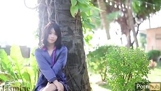 A beautiful Asian girl plays with a vibrator and dildo in the garden