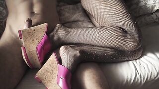 A seductive girl in stockings and high heels, teasing with her enticing feet