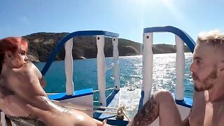 A couple has sex on a boat in the ocean, with someone watching