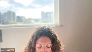 Cute wife showcases her skills in front of passers-by through the window