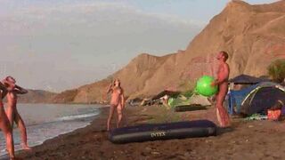 A hot girl is playing badminton naked on the nude beach