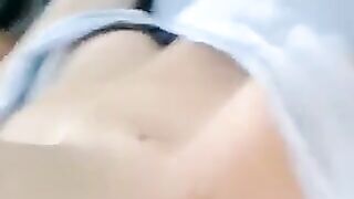 A half-naked girl is lying on her bed and playing with herself