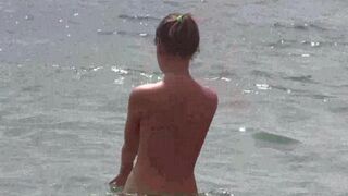 Nudist beauties have fun on the beach without clothes
