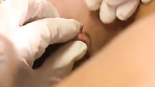 A girl with a nice pussy plays with a sex toy and her piercing