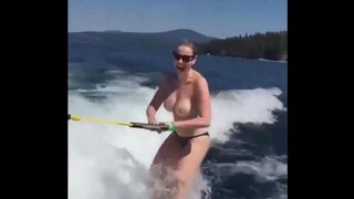 A topless girl has fun on the water skiing