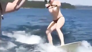 A topless girl has fun on the water skiing