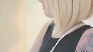 A tattooed girl plays with her pussy with her fingers and a glass dildo