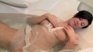 A lonely brunette woman caresses herself with her fingers in the shower