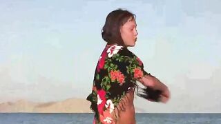 A member shows a naked girl in a public place on the beach