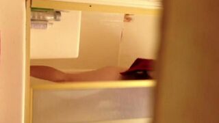 A girl washes in the shower, not knowing there’s a camera
