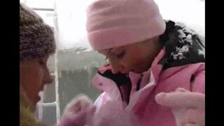 Two girls are having fun on a cold winter day, bringing some heat to the forest