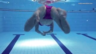 A naked girl is swimming in the pool
