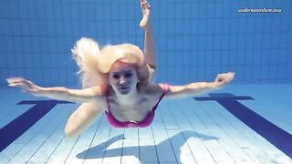 A naked girl is swimming in the pool