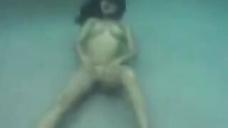 A busty brunette has sex right in the ocean, deep underwater