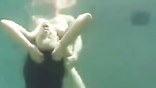 A busty brunette has sex right in the ocean, deep underwater