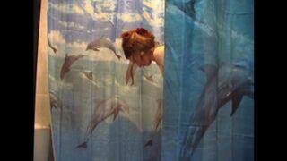 A man shoots his naked wife in the bathroom with a camera