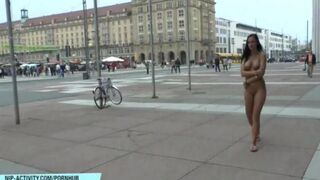 A hot chick is walking naked in the city streets and alleys
