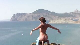 A girl in various poses naked on the sandy coast of the ocean