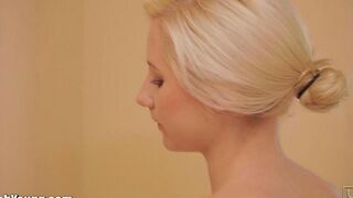 The beautiful woman plays with herself with a brush in her hand