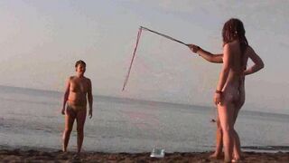 A couple has fun on the beach without any clothes on