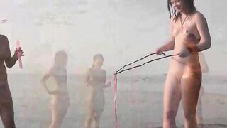 A couple has fun on the beach without any clothes on