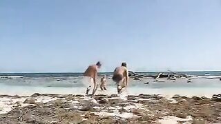 Blonde girl has sex with two guys on the beach