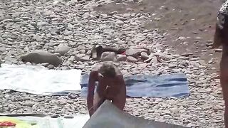 A couple of free-spirited nudists enjoying beach life
