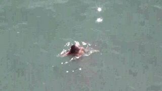 A couple of naked people in the middle of the sea, it's beautiful