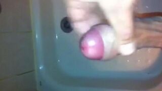 The kid caresses himself with his hand in the shower, trying not to cum