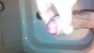 The kid caresses himself with his hand in the shower, trying not to cum