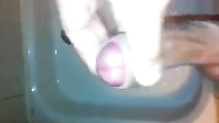 The kid caresses himself with his hand in the shower, trying not to cum