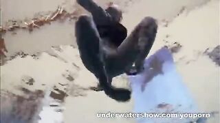 A hot chick is floating in the swimming pool without any clothes