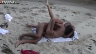 A couple has sex on the beach without any obstacles