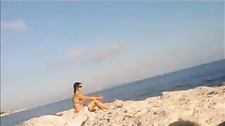 A hot girl is basking in the sun completely naked