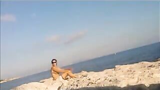 A hot girl is basking in the sun completely naked