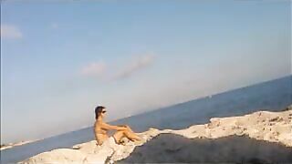 A hot girl is basking in the sun completely naked