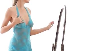 A hot chick is doing erotic moves in front of the mirror with a great ass