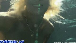 Blonde girl making blowjob under the water