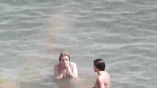Two sexy naked girls bathing in the sea, enjoying a sensual moment
