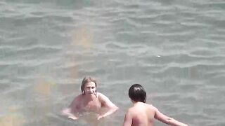 Two sexy naked girls bathing in the sea, enjoying a sensual moment