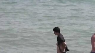 Two sexy naked girls bathing in the sea, enjoying a sensual moment