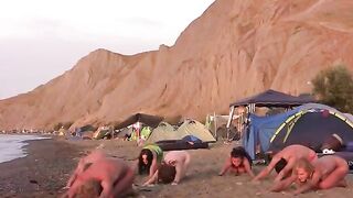 A group of nudists play volleyball without any clothes