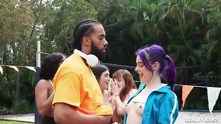 A young guy has fun with girls in the fresh air
