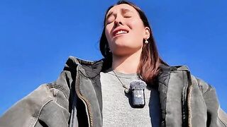 A petite babe masturbates on the public beach with a mini skirt