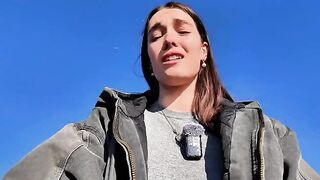 A petite babe masturbates on the public beach with a mini skirt